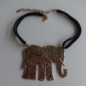 St Thomas marked gold tone elephant pendant (3&1/2") on a 4 strand cord necklace